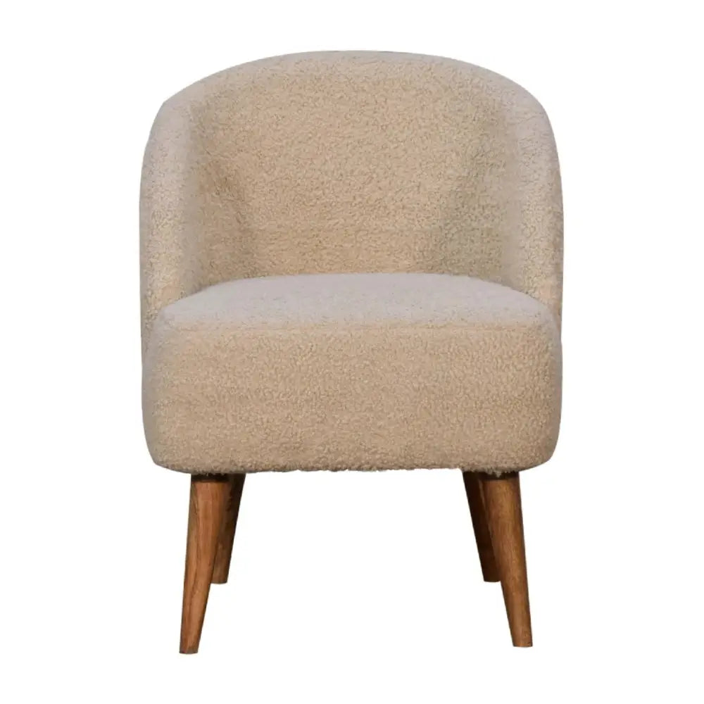 Cream boucle tub chair with beige faux fur upholstery and tapered wooden legs for cozy seating