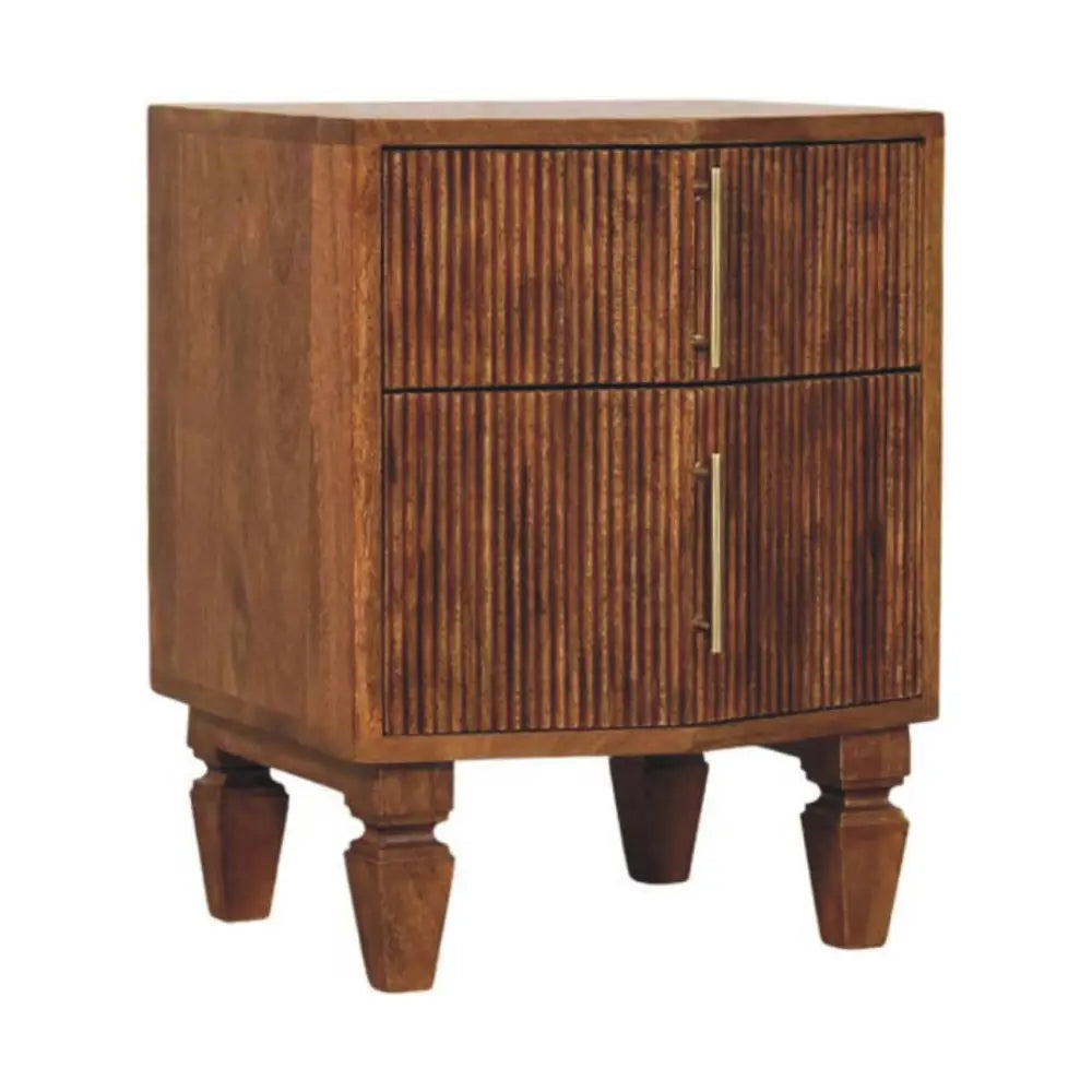 A rustic louvre bedside unit in solid mango wood with vertical slat drawers and slender gold toned handles