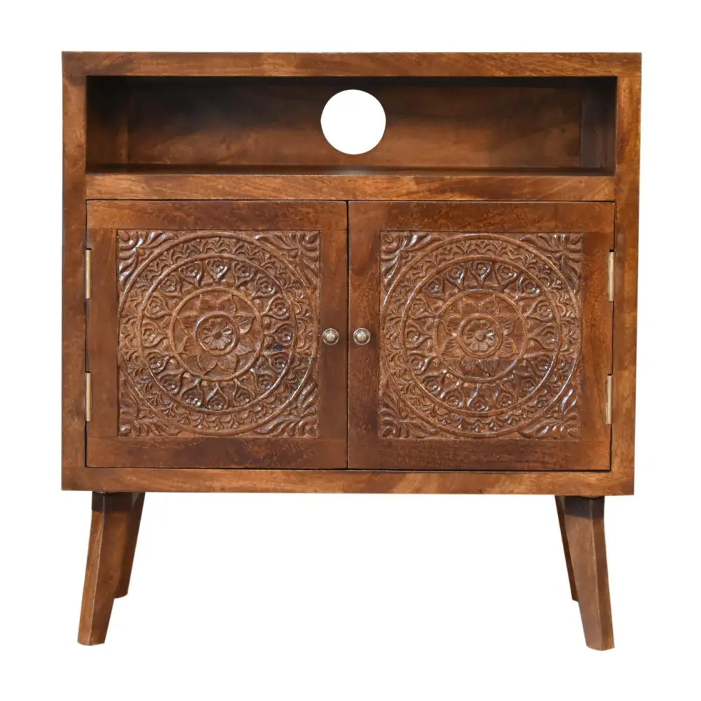 Brown wooden Tova open shelf cabinet with intricately carved mandala doors and a circular cutout on the top shelf