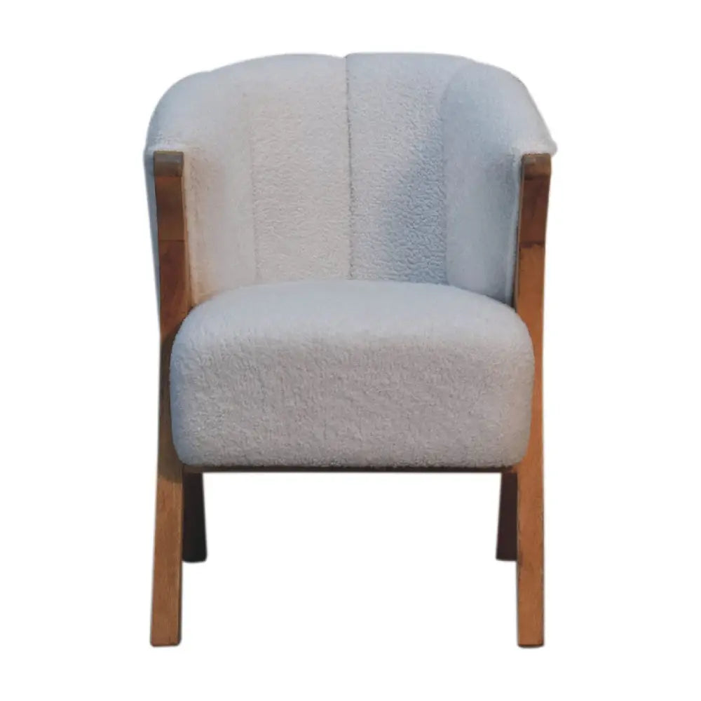 Cozy light gray white boucle minimalistic chair with plush textured fabric and warm wooden frame for stylish comfort