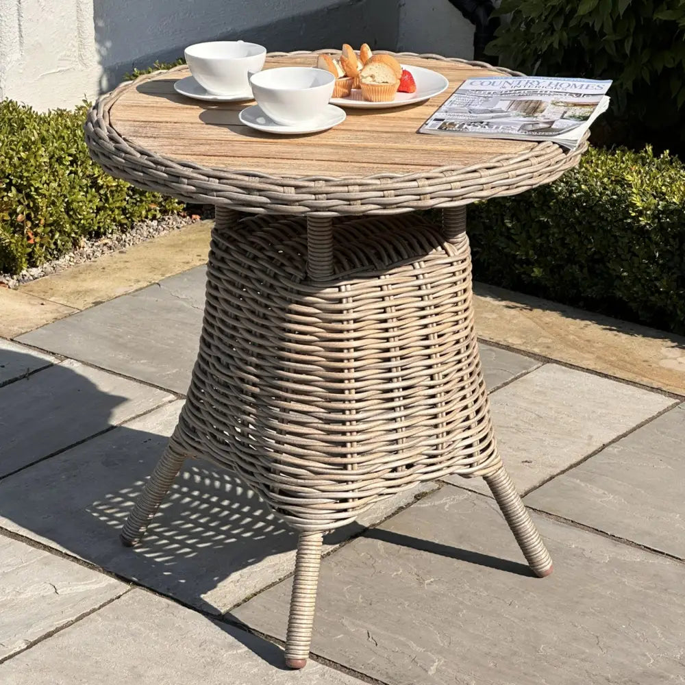 Beige wicker amalfi collection outdoor bistro table with round wooden top and three legs for garden use