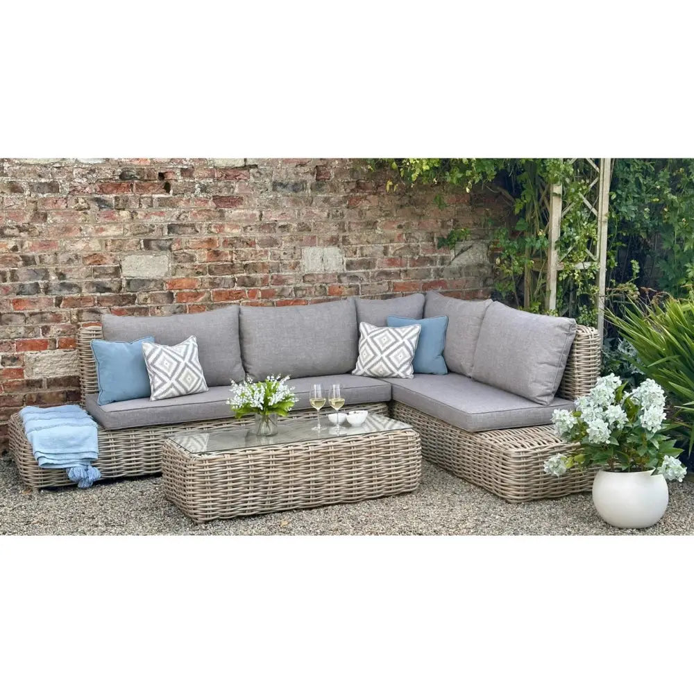 Gray wicker amalfi collection outdoor large corner sofa set with matching coffee table and blue accent pillows