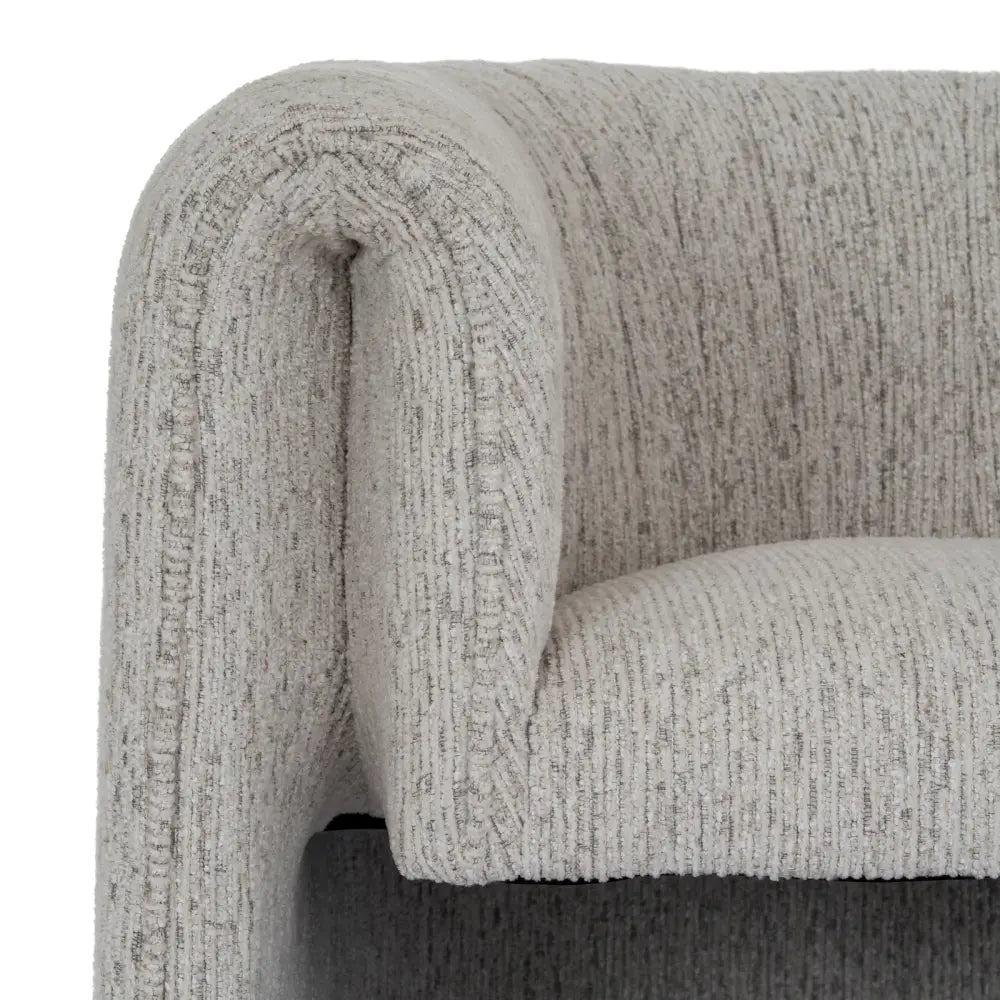 A plush avia mist armchair in light gray textured fabric with a curved cushioned design for cozy seating