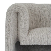 A plush avia mist armchair in light gray textured fabric with a curved cushioned design for cozy seating