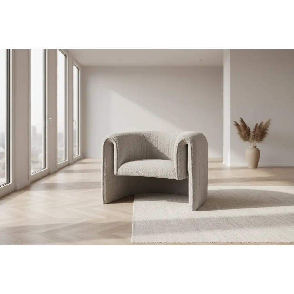 A sleek light gray upholstered avia mist armchair with modern curved design and tufted detailing