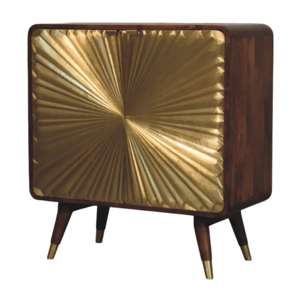 A mid-century modern avora brass embossed 2 door chestnut cabinet with dark wood frame and gold sunburst pattern front panel