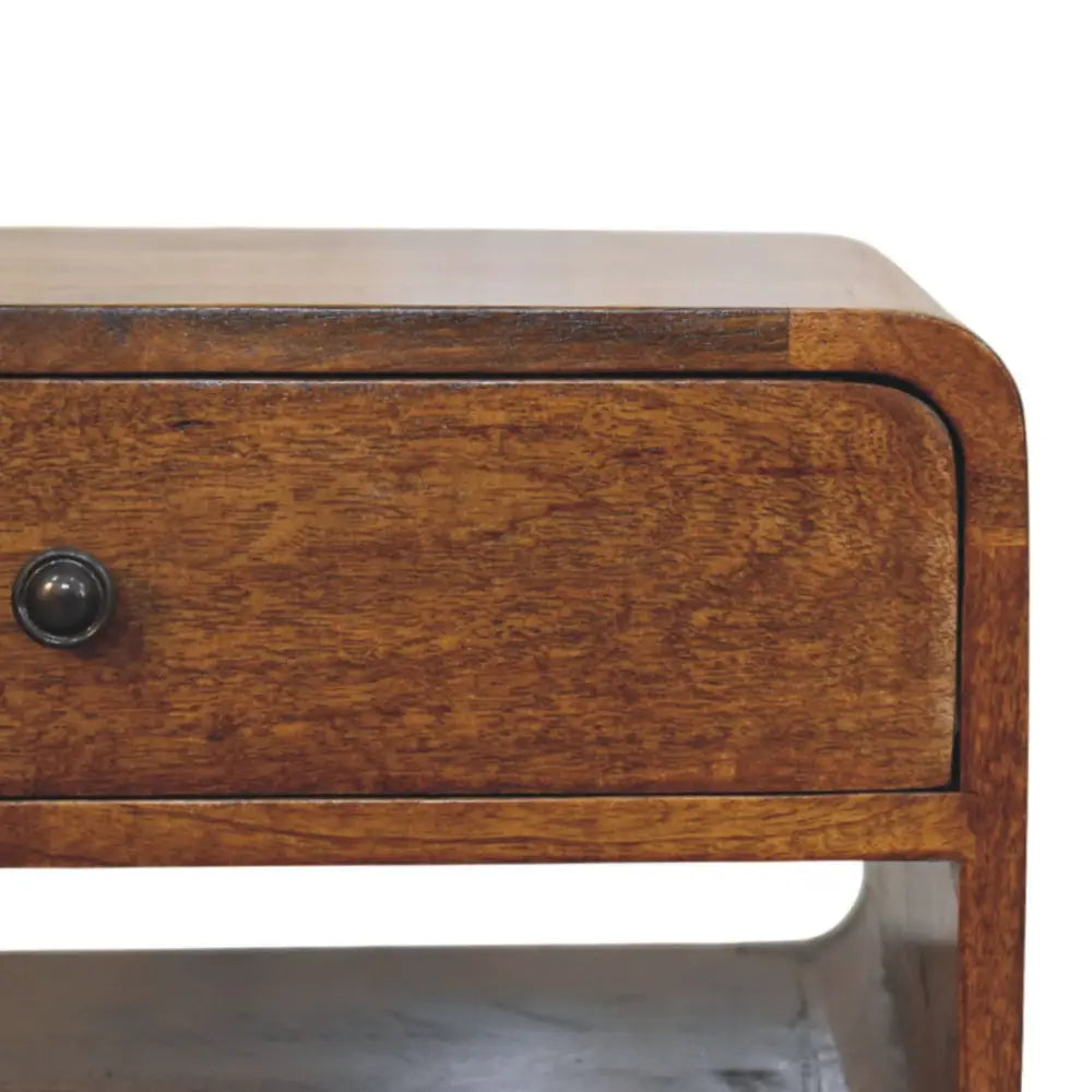 Avora chestnut nightstand with drawer and open slot in warm medium brown solid mango wood with curved front edge and metal knob