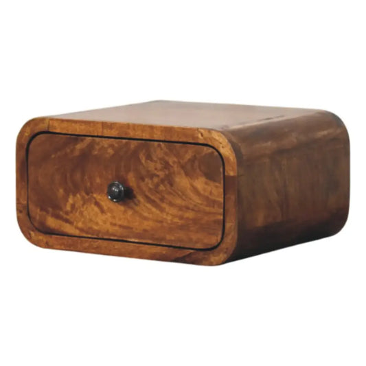 A sleek amber mini wall-mounted nightstand made of solid mango wood with one drawer and rounded edges
