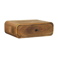 A sleek light brown solid mango wood nightstand with one drawer and rounded edges perfect for wall mounting