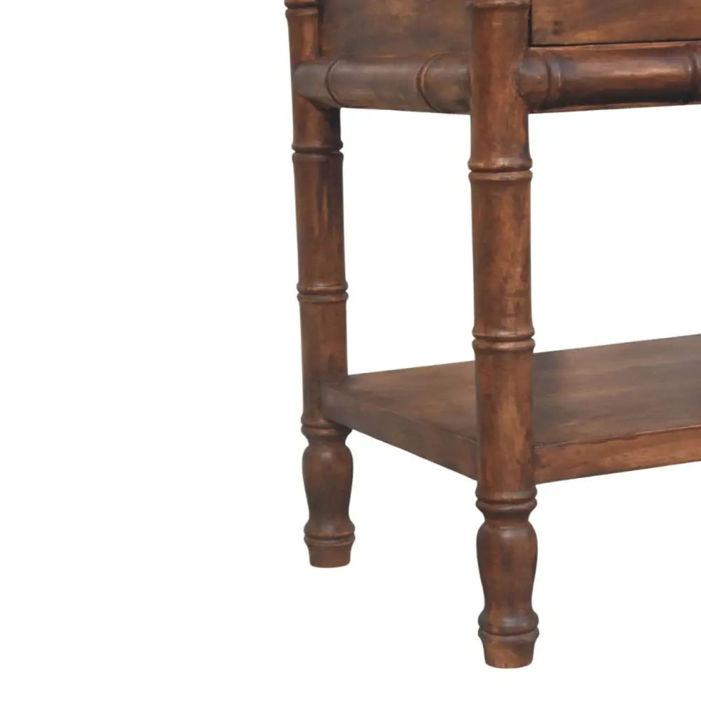 Dark brown bamboo carved bedside table with bamboo-style legs and lower shelf made of solid mango wood