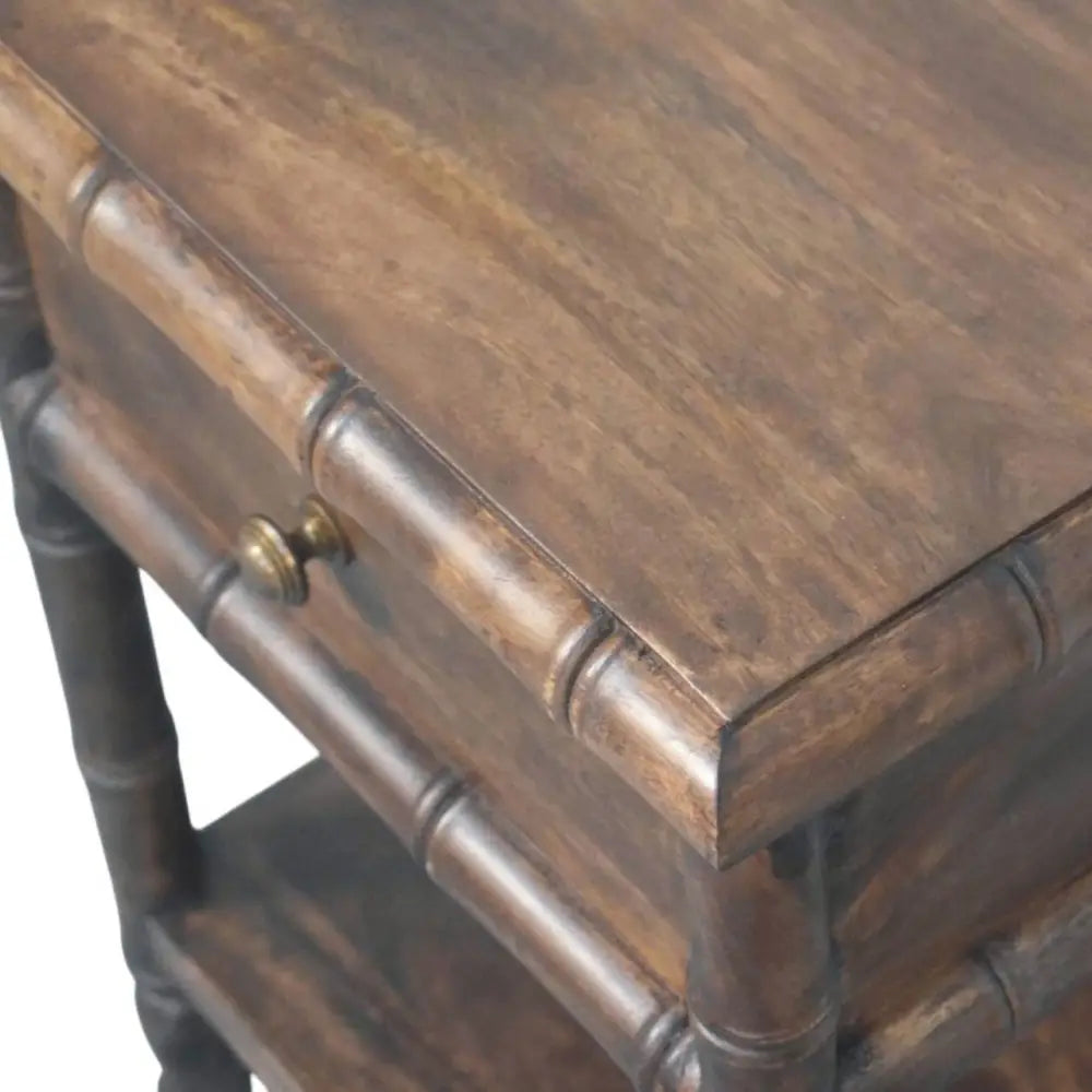 Dark brown bamboo carved bedside table with single drawer and brass knob made from solid mango wood