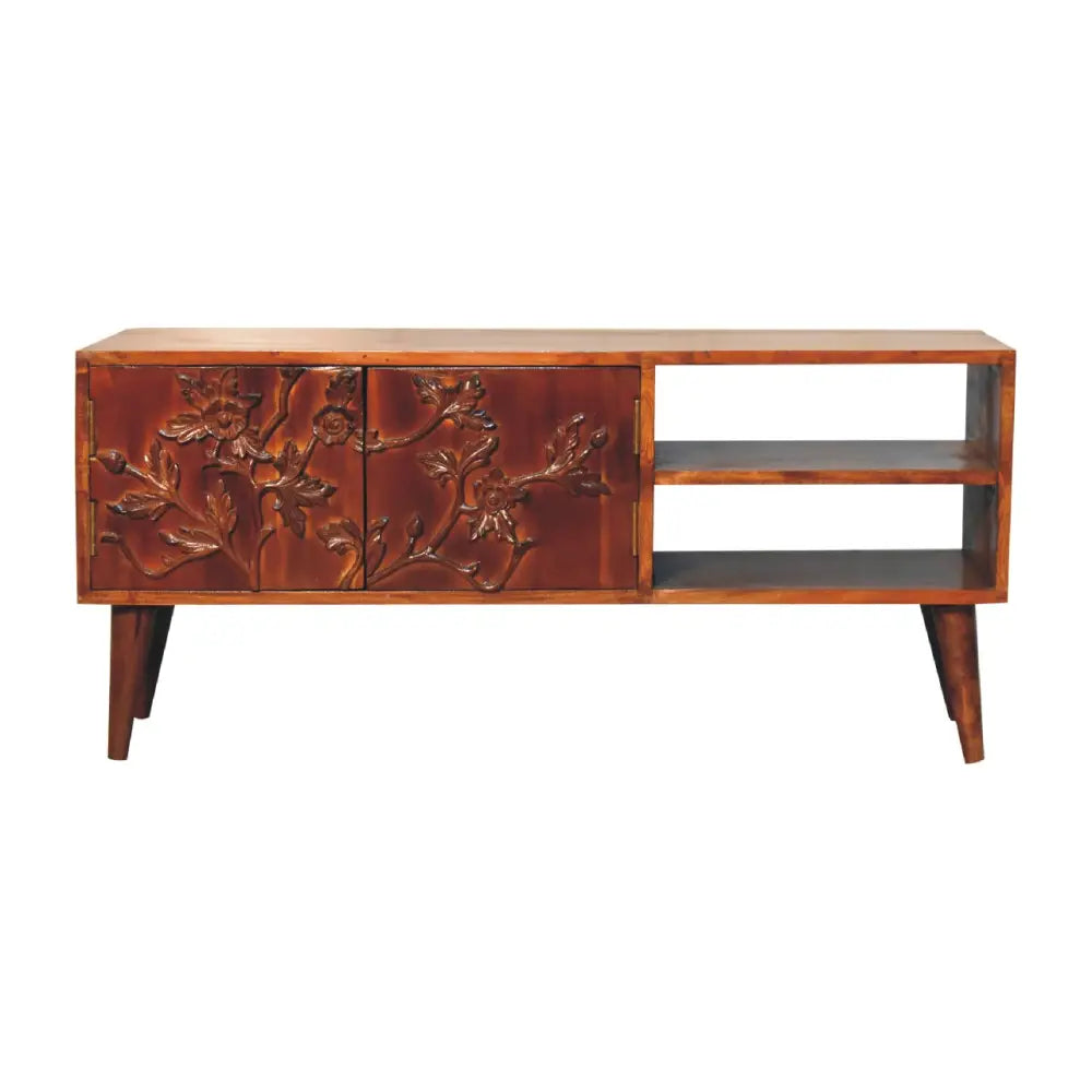 A rich dark brown wooden botanic media unit with intricately carved floral and vine patterns on its doors