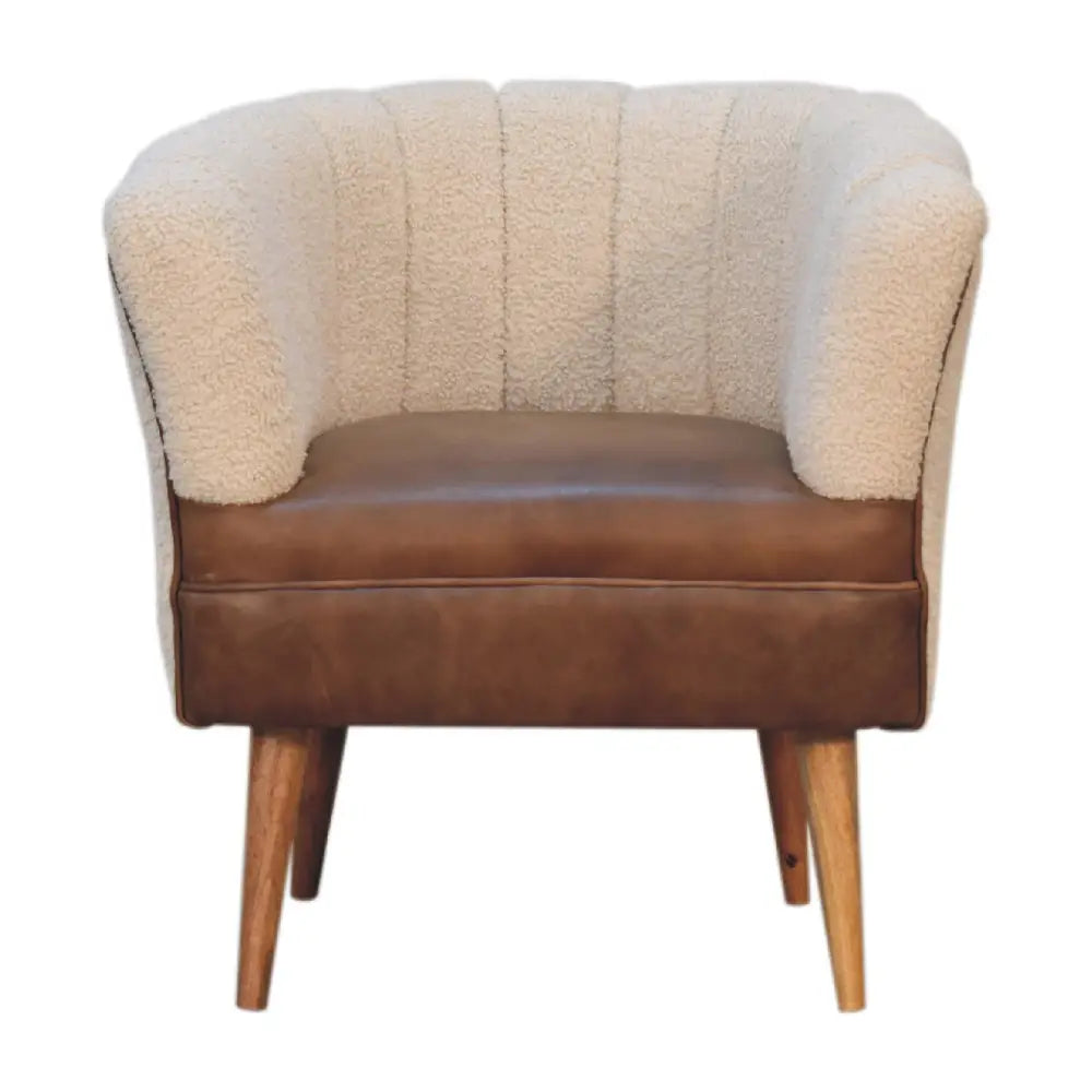 Cream buffalo armchair with boucle cream tufted sheepskin, brown leather seat, and wooden legs for cozy seating