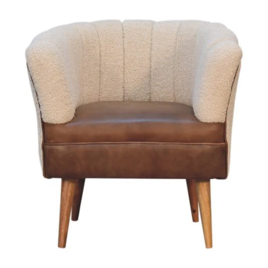 Cream buffalo armchair with boucle cream tufted sheepskin, brown leather seat, and wooden legs for cozy seating