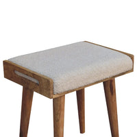Cozy boucle cream tray style footstool with off-white sheepskin cushion and natural wood tapered legs