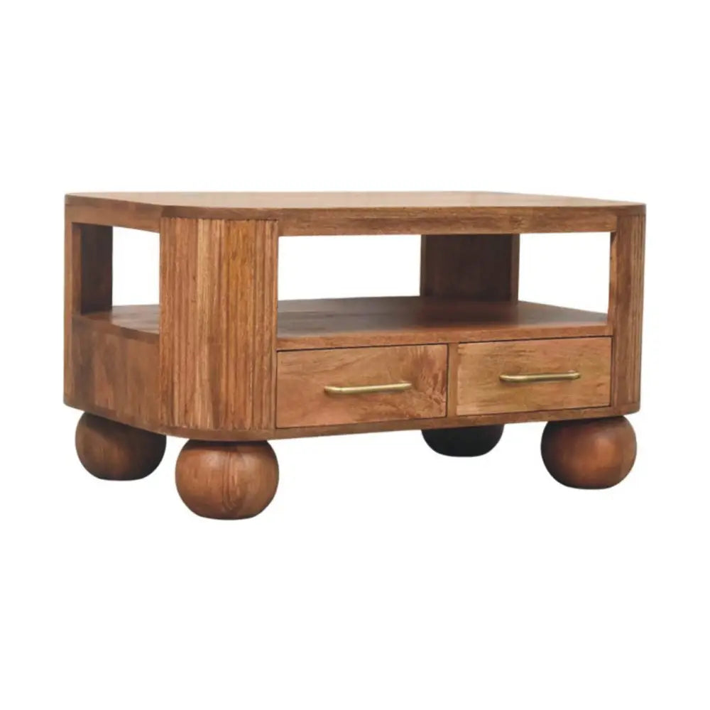 A warm-toned briarwood fluted coffee table with rounded ball feet and two drawers with brass handles