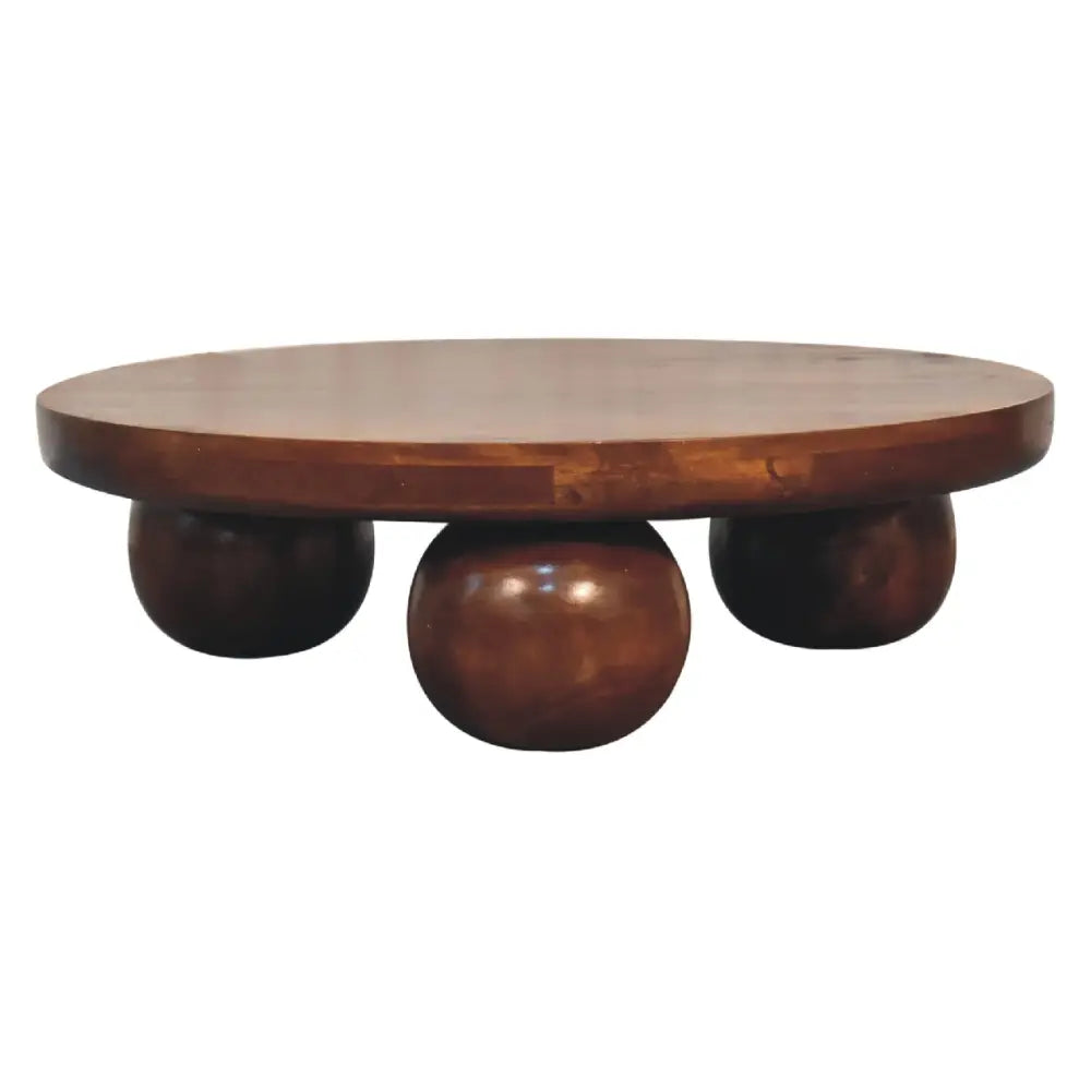 Dark green leather tufted chesterfield sofas paired with a chestnut central ball table for stylish living room setup