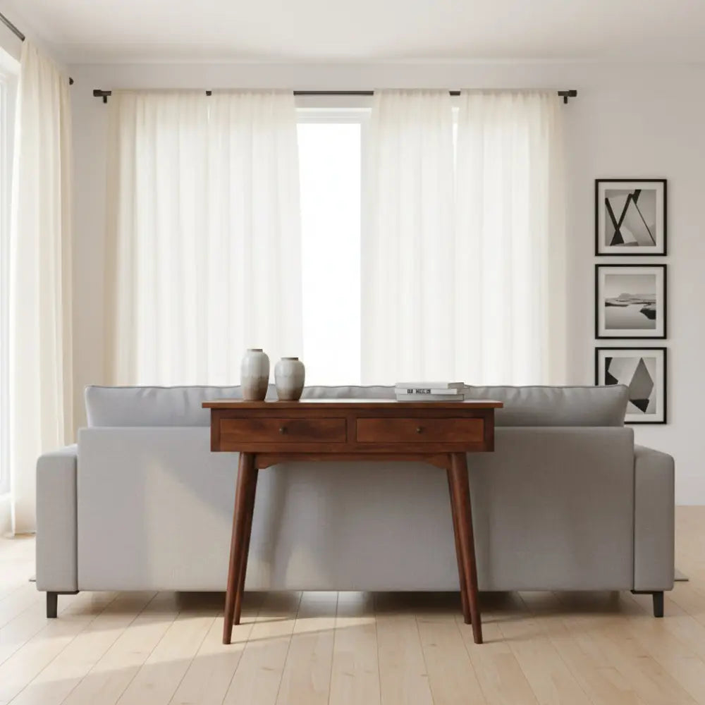 A sleek dark wood chestnut hallway console table with two drawers and tapered legs for stylish storage