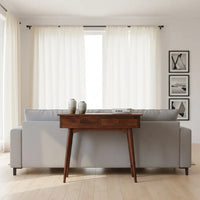 A sleek dark wood chestnut hallway console table with two drawers and tapered legs for stylish storage