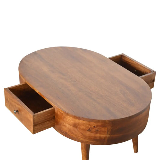 Warm-toned chestnut rounded coffee table with two side drawers and slender legs made from solid wood