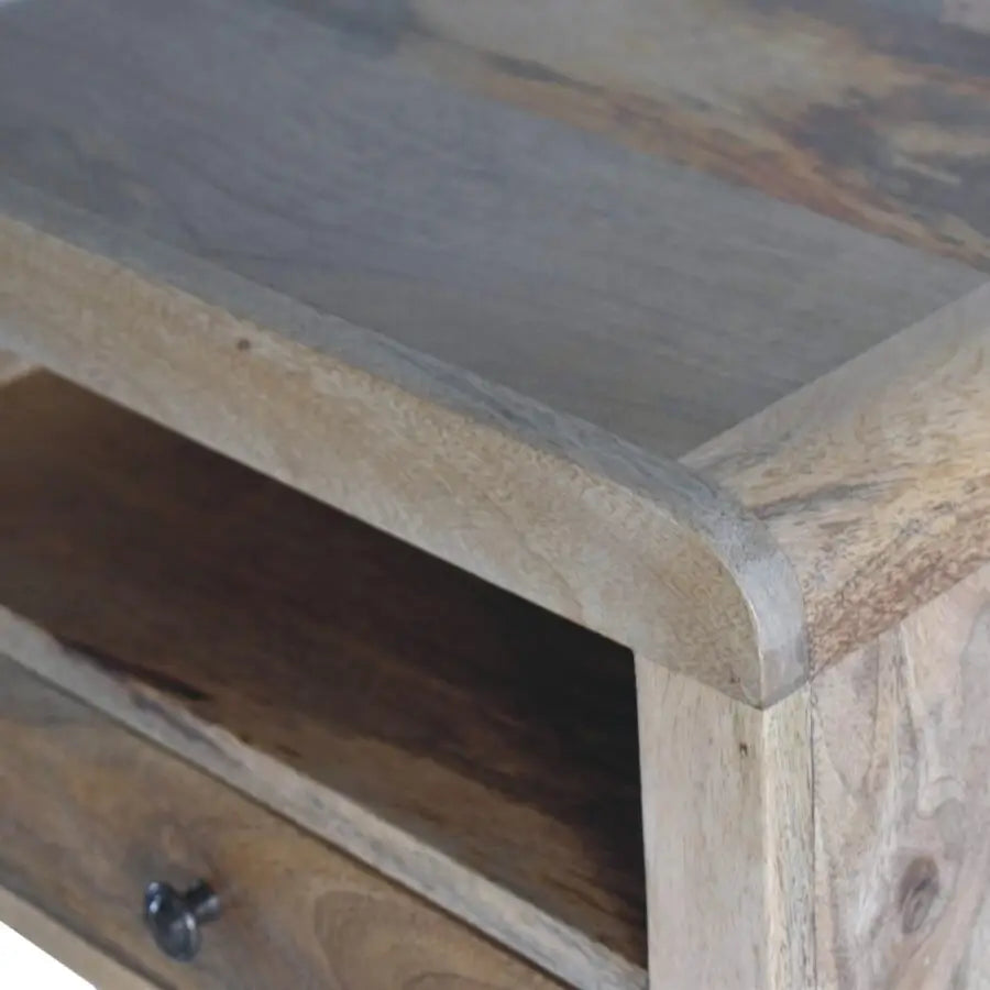 A chunky oak-ish floating bedside with a rustic weathered finish, single drawer, and open shelf for storage
