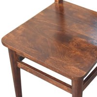 Classic chestnut dining chair made of dark brown wood with polished finish and visible wood grain