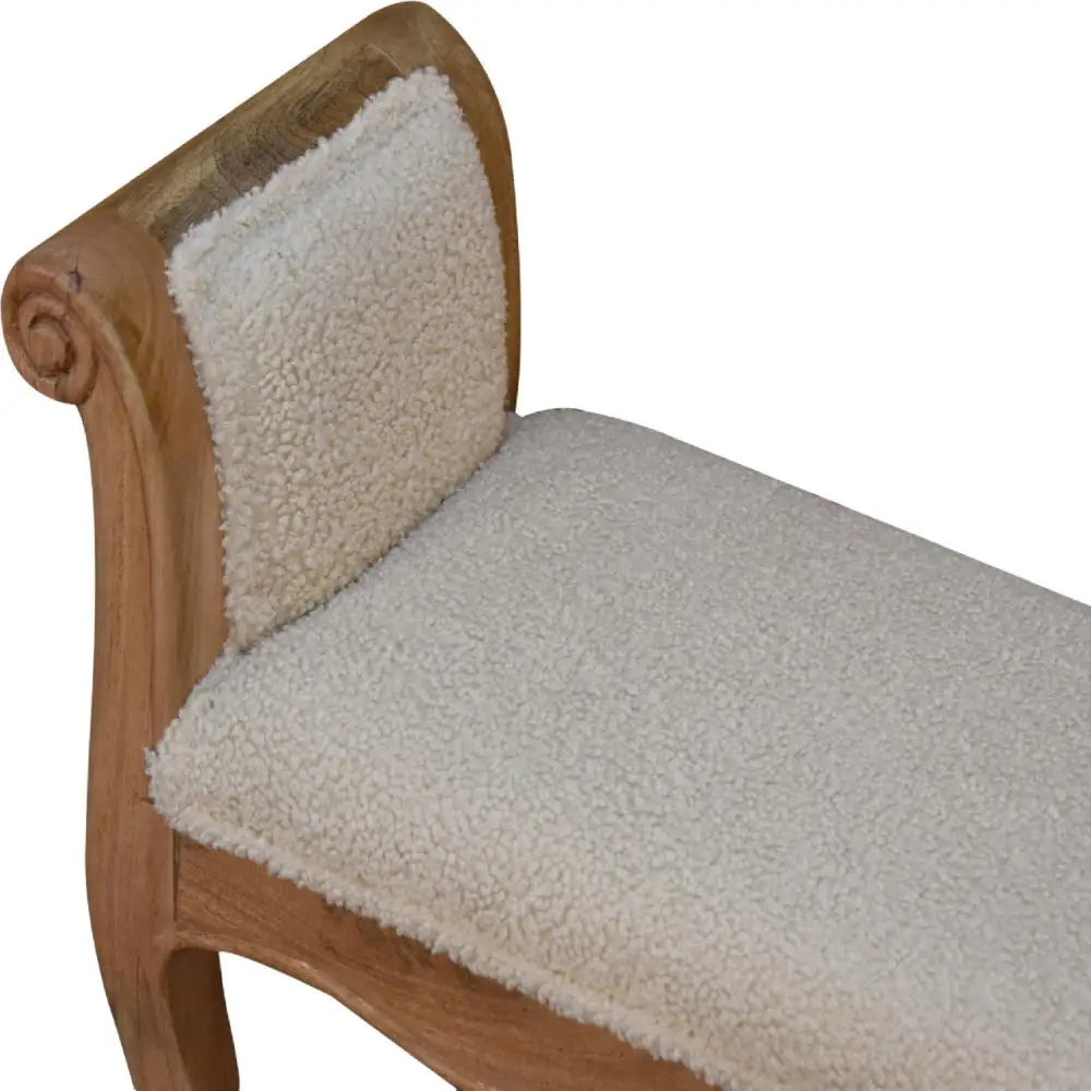 A cozy cream boucle french style bench with shearling seat and warm light wood frame featuring curved scrollwork