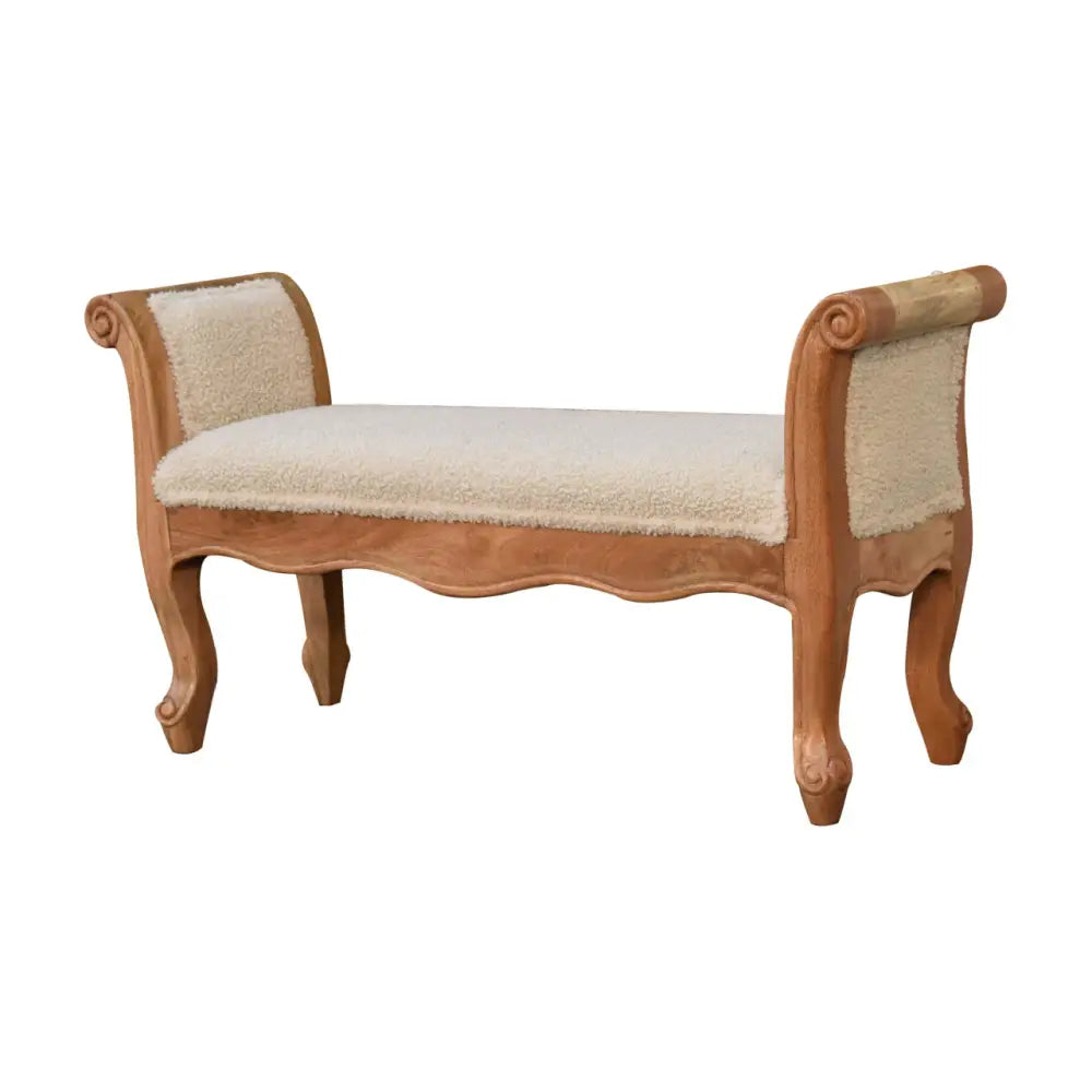 Beige upholstered bench with carved light wood frame and scrolled legs in cream boucle french style design