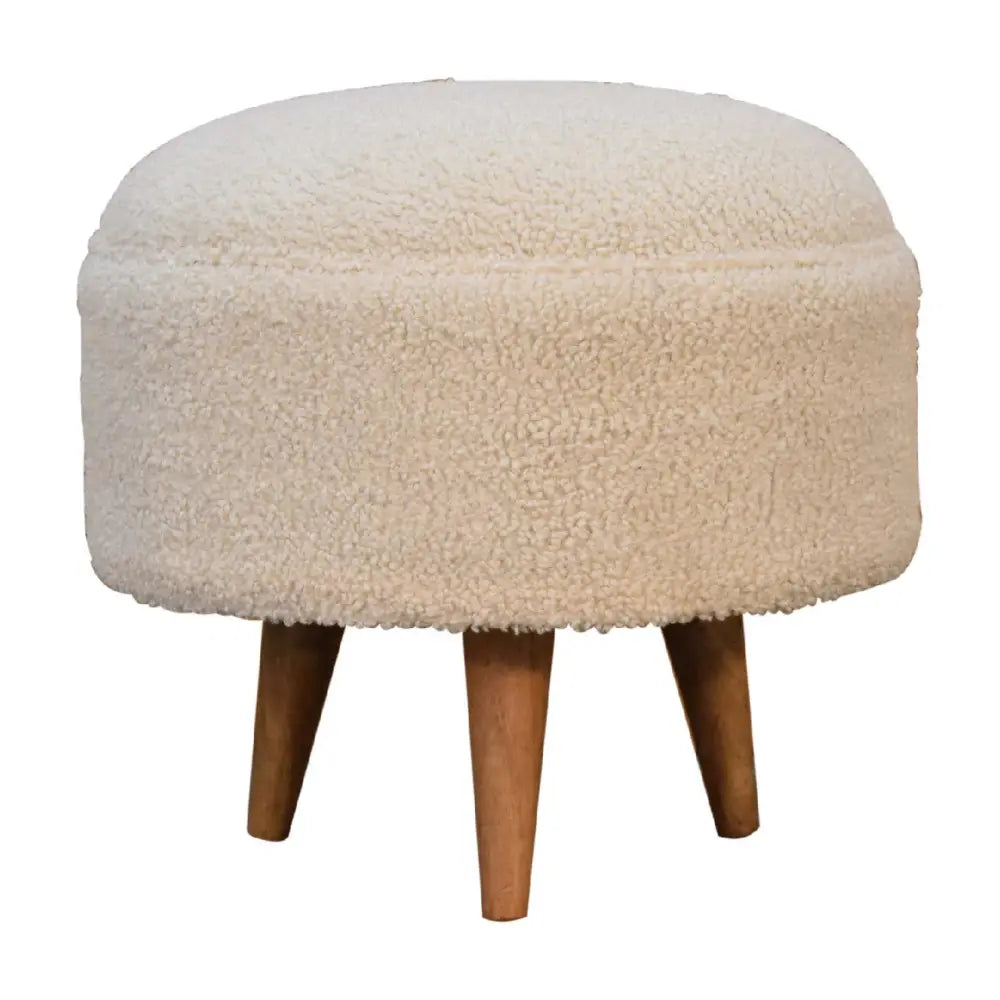Cream boucle rounded plush sheepskin textured footstool with tapered wooden legs perfect for cozy seating