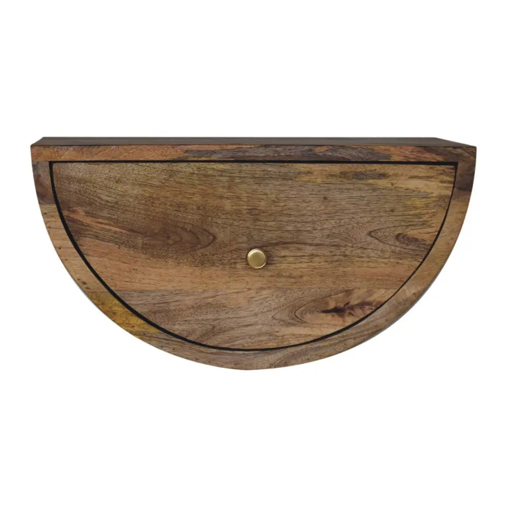 Half-moon shaped wooden drawer with brass knob and warm natural wood grain in a crescent floating bedside unit