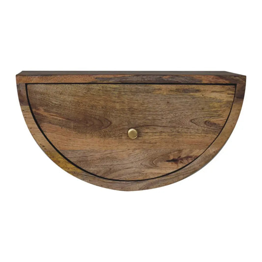 Half-moon shaped wooden drawer with brass knob and warm natural wood grain in a crescent floating bedside unit