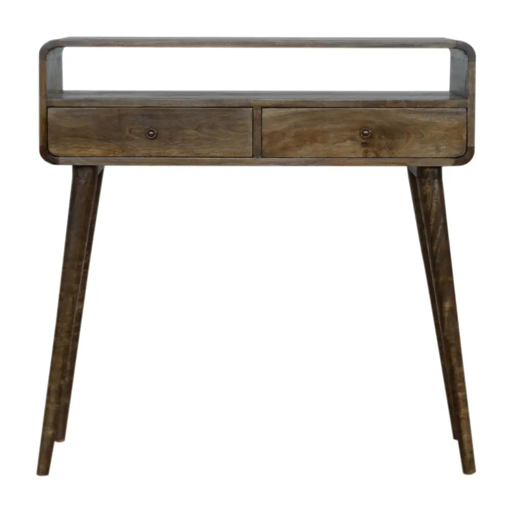 A rustic wooden console table with tapered legs curved grey wash and two drawers with a curved top edge