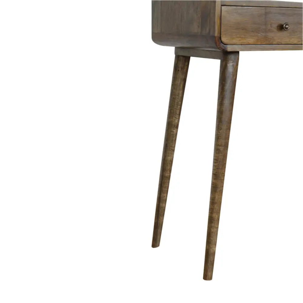 Curved grey wash wooden console table with tapered legs and single drawer featuring round metal knob