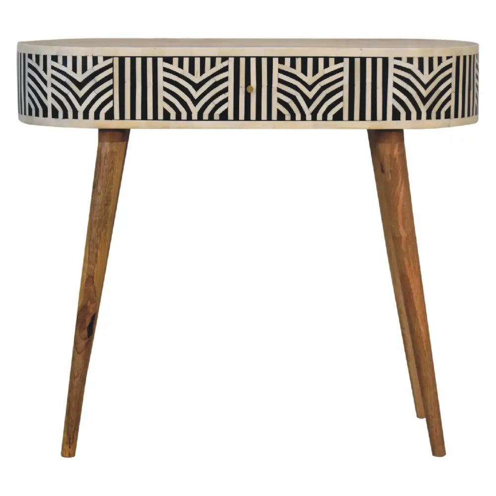 A sleek oval edessa bone inlay console table with black and white geometric pattern and tapered wooden legs