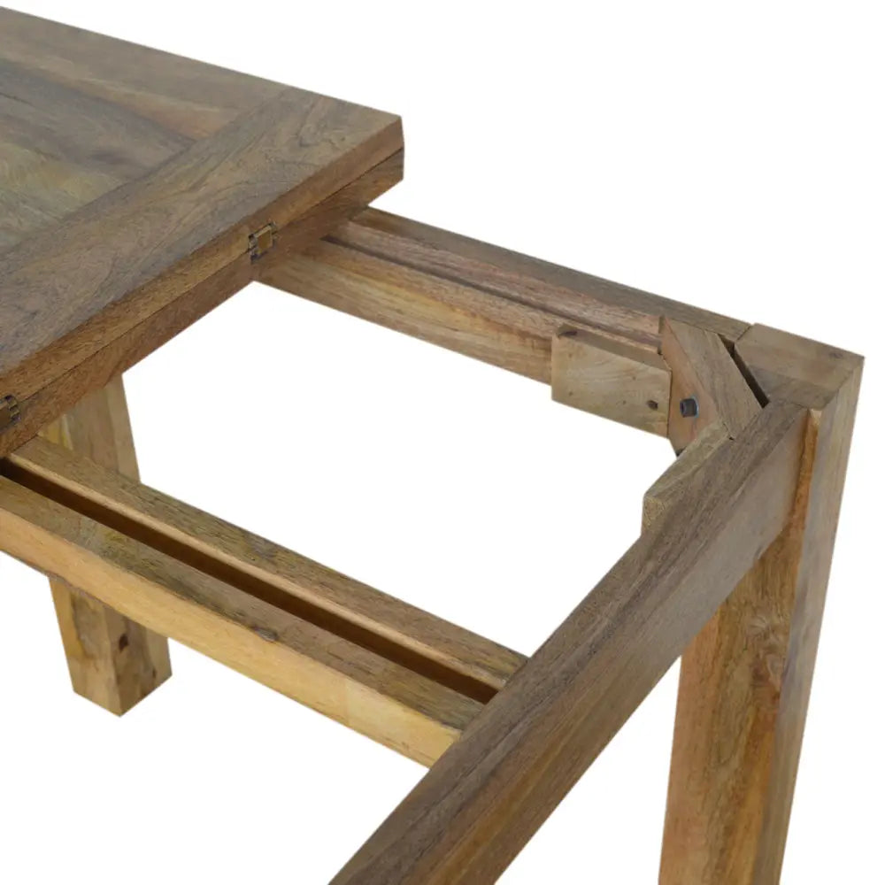 Rustic wooden extendable butterfly dining table with natural finish and sturdy legs showing sliding extension mechanism