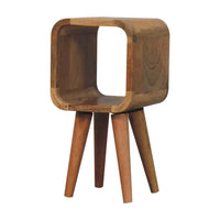 A sleek extra mini minimalist wooden side table with rounded edges and three tapered legs in oak finish