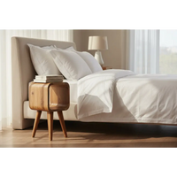 A sleek extra mini minimalist light wood nightstand with curved oak design and tapered legs for bedside use