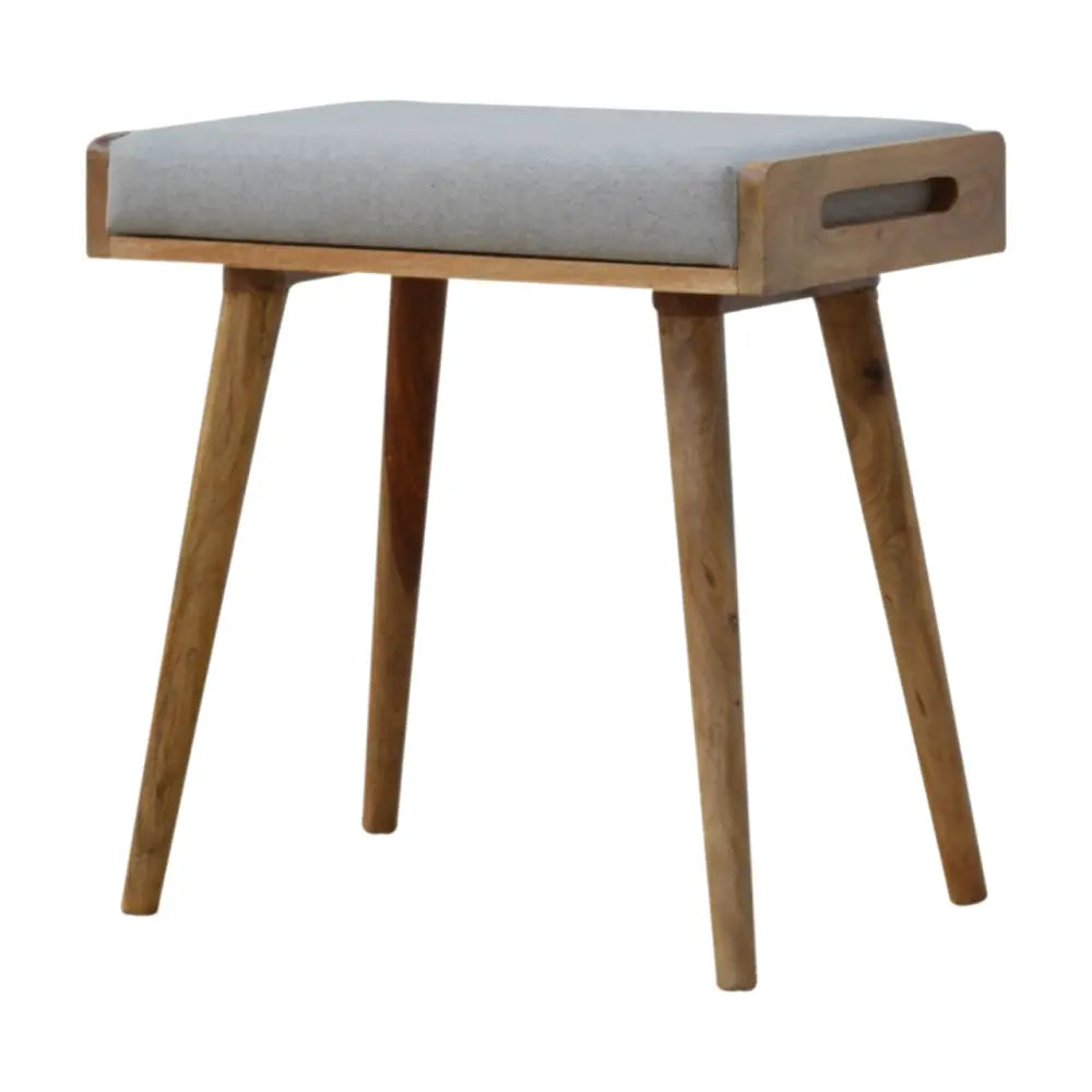 A mid-century modern wooden grey tweed tray style footstool with a light gray upholstered seat and tapered legs