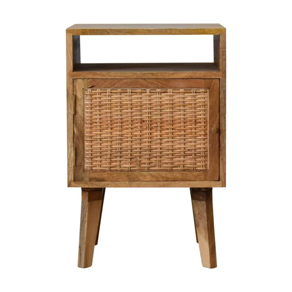 A rustic wooden knit door bedside with woven cane panels and tapered legs perfect for cozy bedroom storage