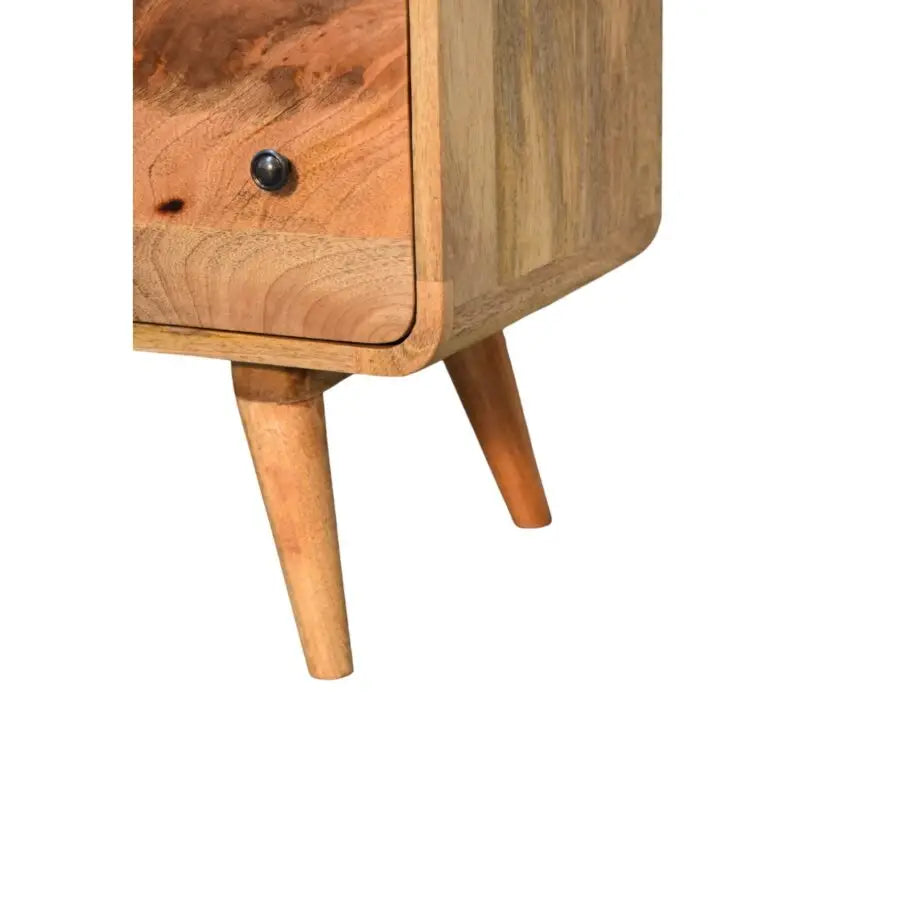 A large curved oak-ish nightstand with a natural wood grain and tapered legs, perfect luxury furniture for modern homes