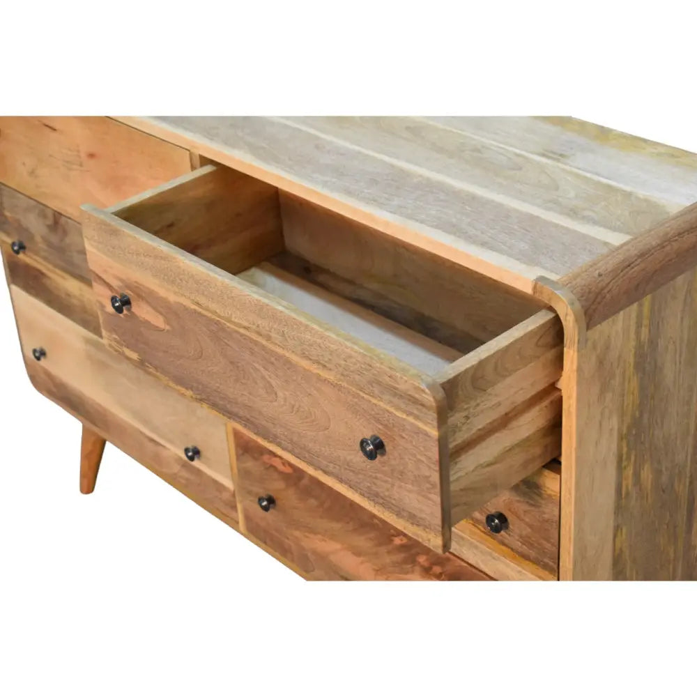 Large curved reclaimed wood dresser with black metal knobs featuring opulent luxury furniture for modern homes