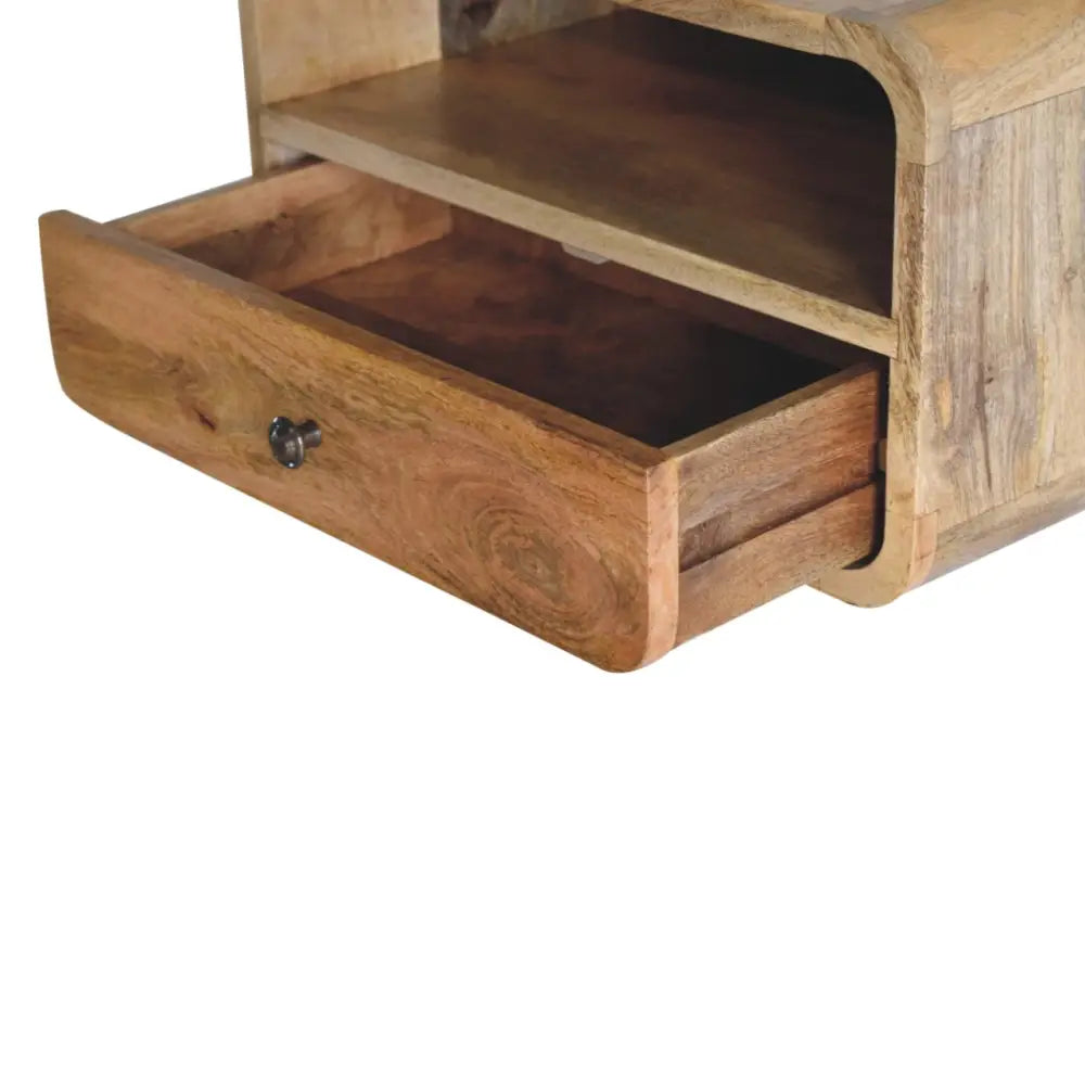A large oak-ish curve upper slot floating wooden nightstand with single drawer, open shelf, and dark metal knob