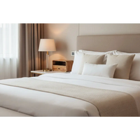 A beige plush bedspread with a subtle weave draped over a large oak-ish curve upper slot floating bedside