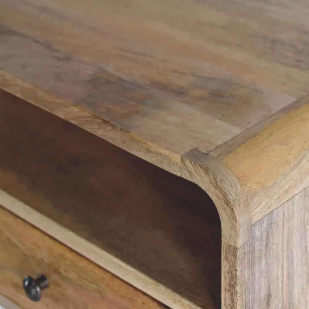 A large oak-ish curve upper slot floating wooden nightstand with warm natural finish and visible grain patterns