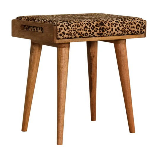 A mid-century modern stool with light wood legs and leopard velvet tray upholstered seat in leopard velvet fabric