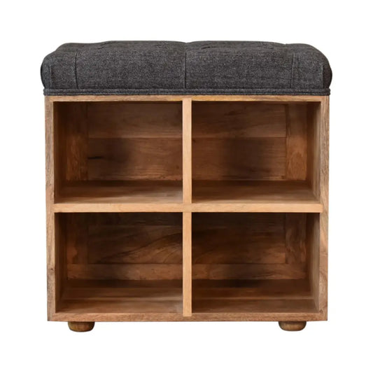 A dark gray tufted fabric top sits on a light wood mini black shoe storage footstool with four open cubbies