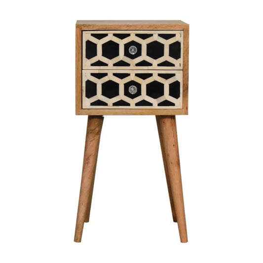 A modern wooden mini bone inlay nightstand with two drawers in black and cream honeycomb pattern on tapered legs