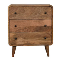 A polished silver knights armor suit displayed on a wooden stand next to a mini curved oak-ish chest luxury furniture for modern homes