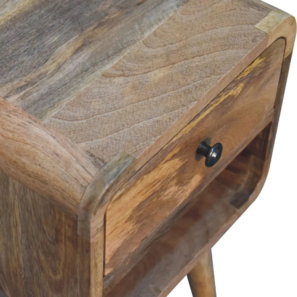 A rustic mini oak-ish curve lower bedside with a curved top drawer in warm brown wood grain and darker streaks