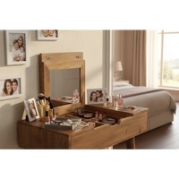 Light brown oak ish wooden mini dressing table with mirror and open drawers holding makeup items